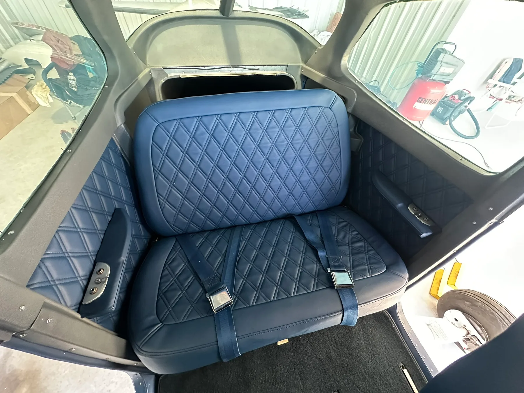 Custom blue diamond-stitched aircraft seats in a Cessna interior by GVO Classic Upholstery
