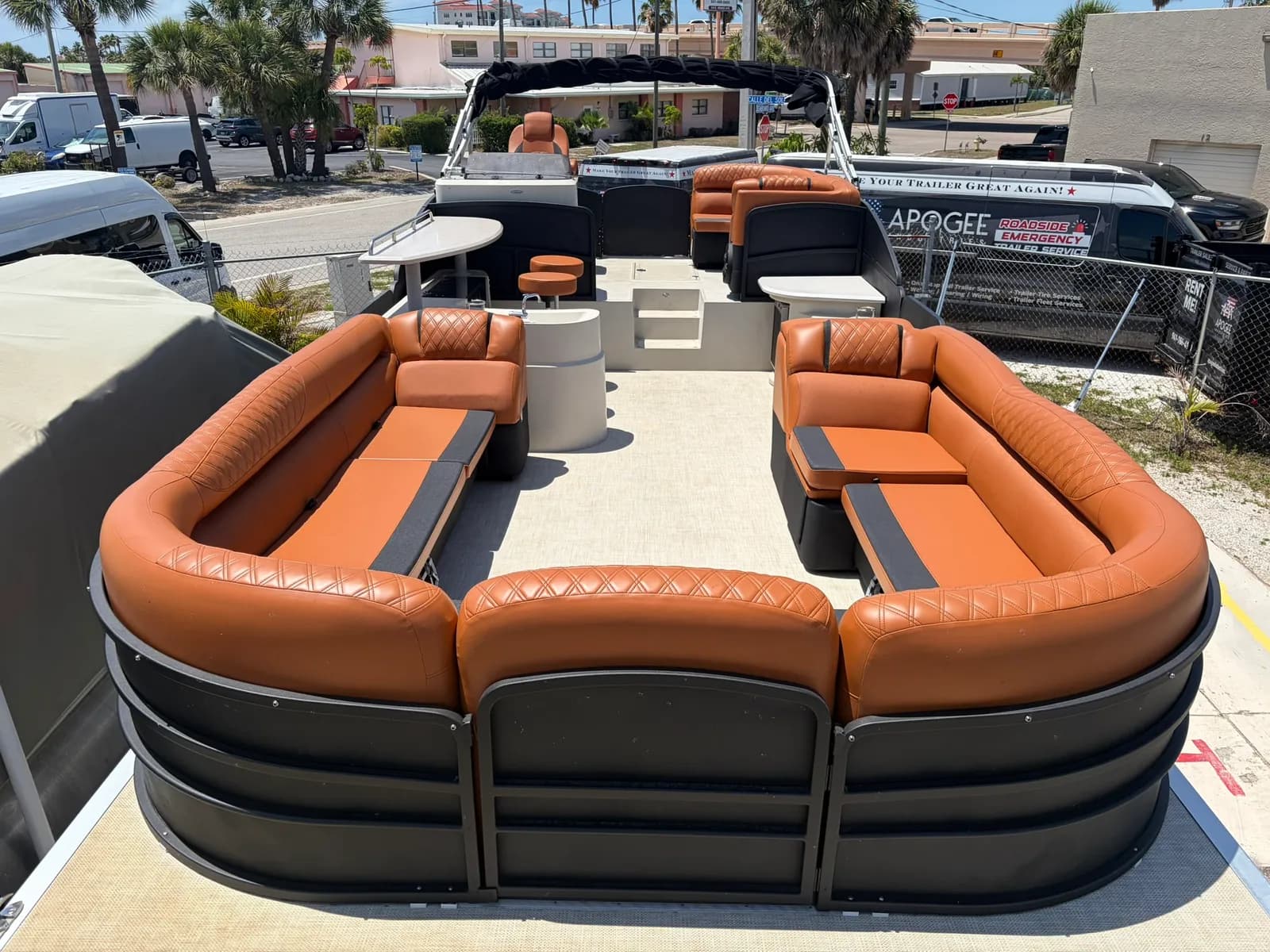 Pontoon boat with custom cognac diamond-stitched wraparound seating by GVO Classic Upholstery in North Port, FL