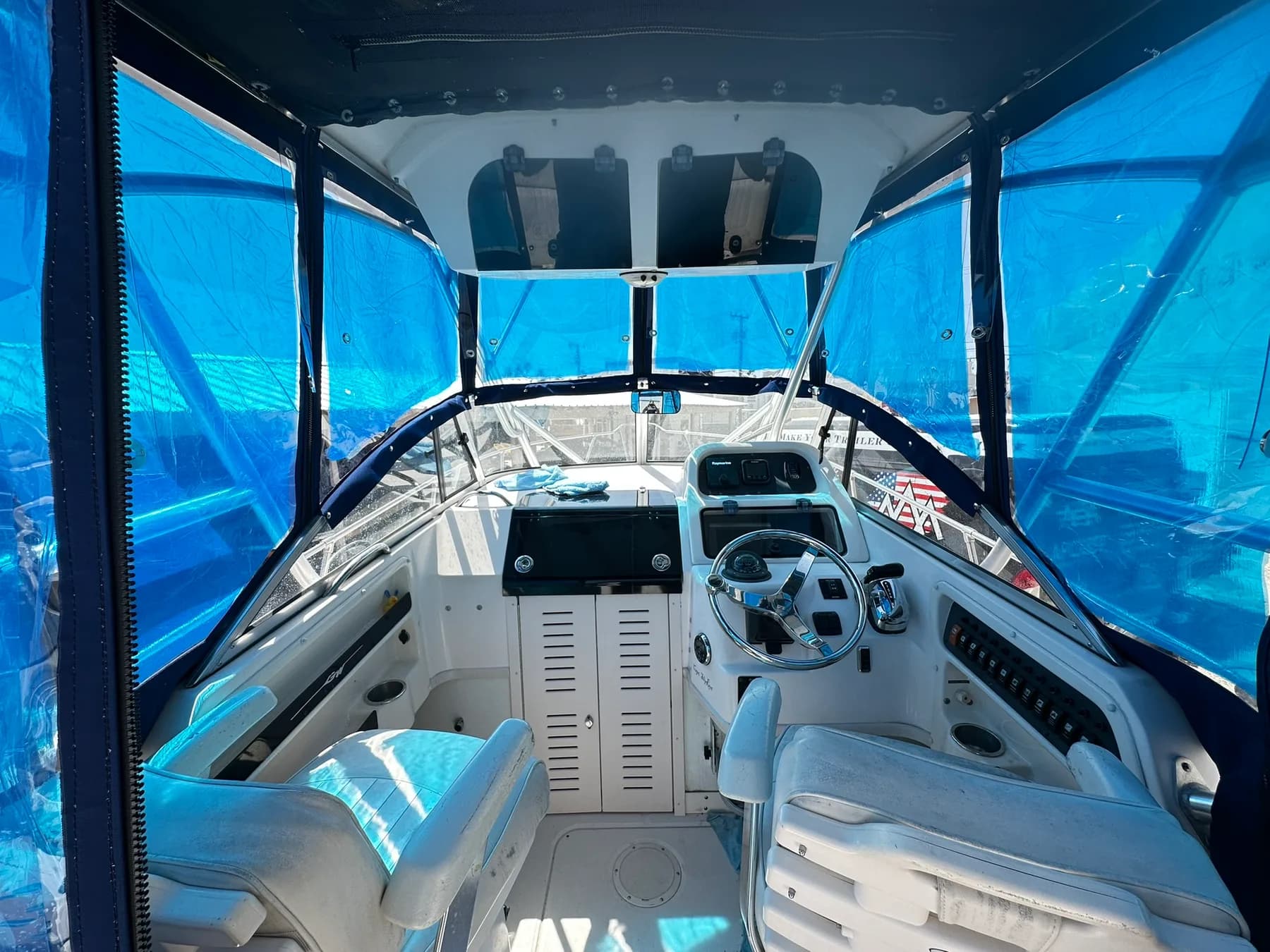 Boat cockpit with custom canvas enclosure and reupholstered seats